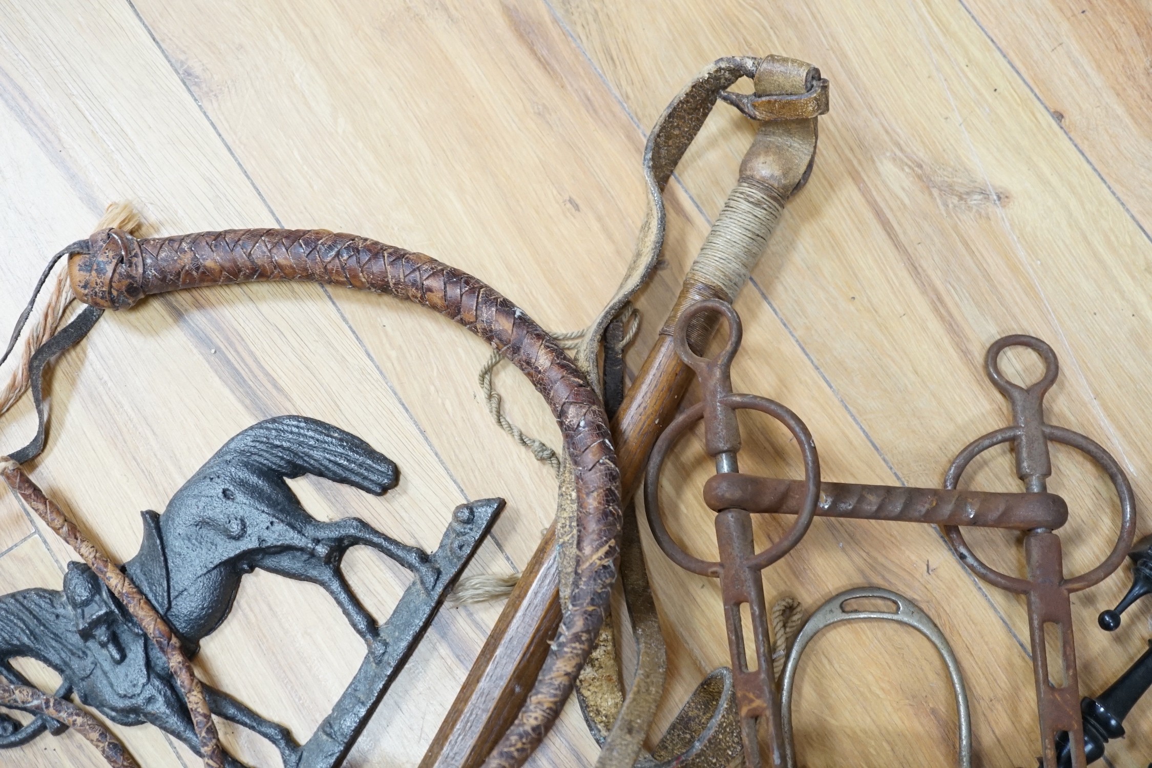 Assorted horse accessories, iron castings, a Disraeli plaque, etc